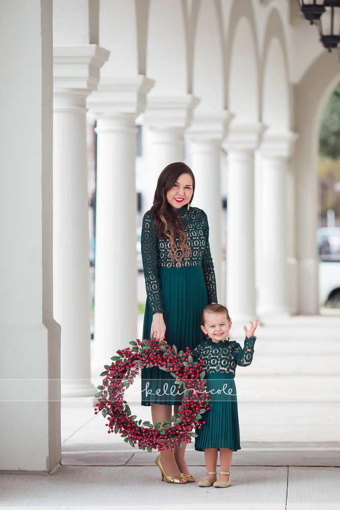 family photo shoot, uptown park, houston family photography, houston family photographer, kelli nicole photography, family, familia, mommy and me, family of two, beautiful family, houston child photographer, houston child photographer, uptown park session, houston galleria family photographer, houston family photographer, family photography, christmas, houston mini sessions, columns, matching dresses, mommy and me dresses, wreath